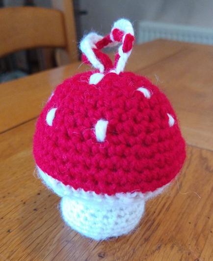 Crochet fly agaric mushroom with a red cap and white spots, and a white stem