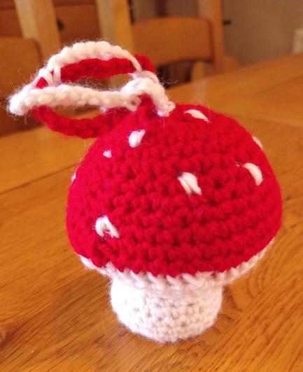 Crochet fly agaric mushroom with a red cap and white spots, and a white stem