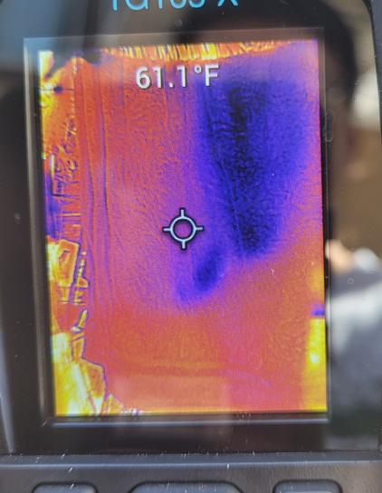 61.1F reading on laundry. Orange areas feel dry. Purple area is dry on surface but damp behind.