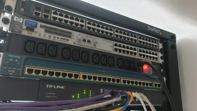 The top of the back of the rack with the PDU installed between a few switches. Plugged in with a cable installed in it.