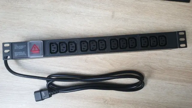 A PDU with 12 C13 plugs and a power switch with a cover on. And a C14 plug for the power-in.