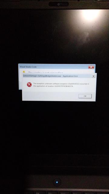 A laptop screen which is almost entirely black, except for two popup windows showing error messages.