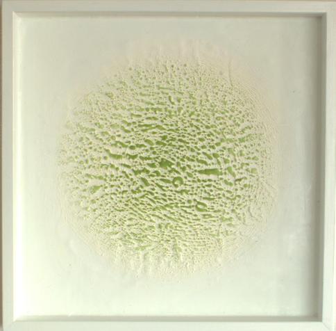 Encaustic painting in white with green accretion.