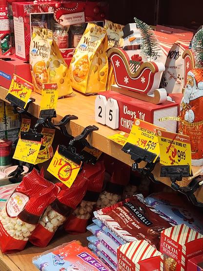 An assortment of discounted Christmas items for sale on a grocery store shelf.