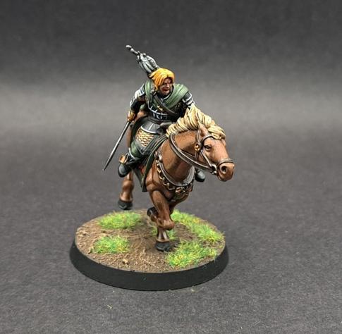 Blonde Horse with blonde Rider wearing a green cape and out holding a sword ready to gouge an orc. Trust me, the painting and shows why Drunk On Tea is worth paying for a commissions