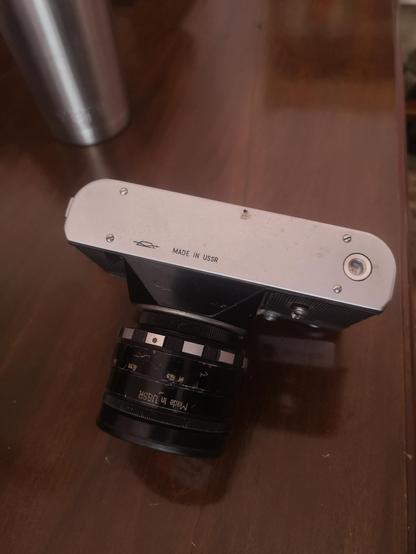 Zenit-e camera underneath shows Made In USSR engraved in both camera body and lens