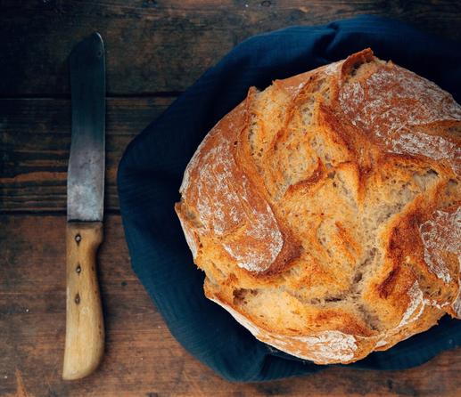 Fresh bread with a knife in moodie light