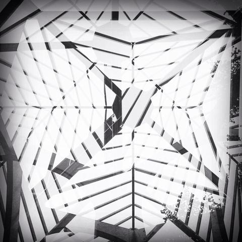 Multiple exposure in b/w and 1:1 format of a stylised roof, consisting of numerous metal struts, of a former monastery. The photo is taken from a frog’s perspective looking upwards.