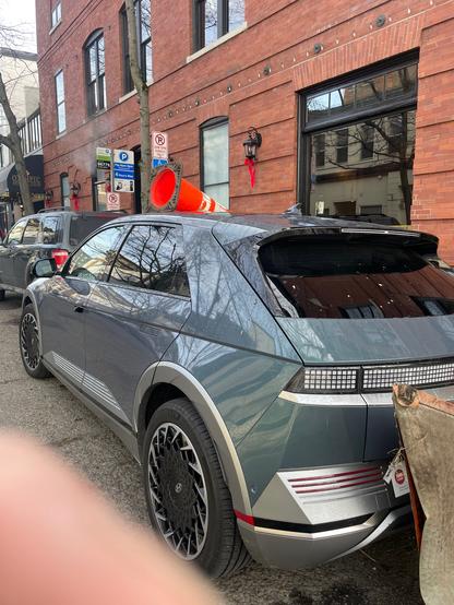 Permitted Hyundai Ioniq5 “parked” in disabled space steps from Olympic Athletic Club pool. Vehicle vandalized with paper detritus and traffic cone.