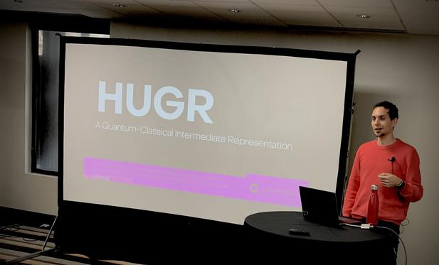 Agustin Borgna giving a talk.  The slide says "HUGR".