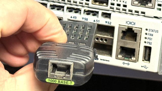 Trying to wedge a GBIC into a QSFP cage.