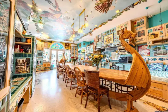 According to the property listing, "the kitchen is dedicated to the Elements of Air and a story of its power is depicted on its ceiling." The vaguely baroque ceiling mural is paired with a bright blue country-style kitchen, and a dining table large enough to seat 20 that's carved to look like the prow of a Viking longship. I cannot begin to express how much the walls are plastered in random vaguely nautically themed things.