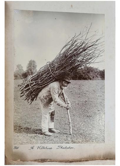 elderly man in a field near London carrying a large bundle of sticks on his back