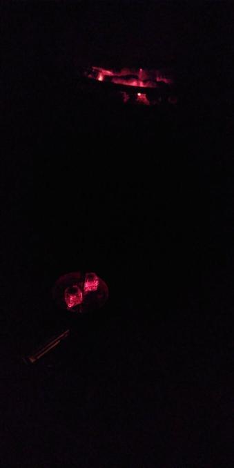 Glowing embers in a oven and two glowing coals on to of a hookah