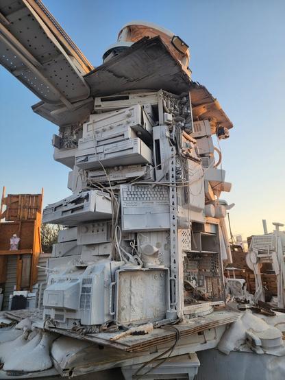 Artistic found sculpture made up of old computer parts in the desert.