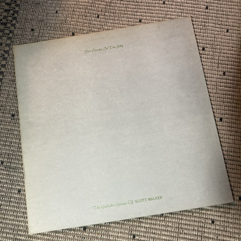Front cover. Flat, grey card with text in small green calligraphic typeface. Title is at the very top, subtitle at the very bottom
