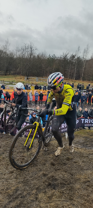 Cyclocrossers pushing their bikes up a ramp