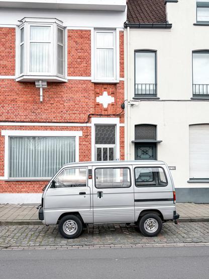 Suzuki Carry van in front of a house