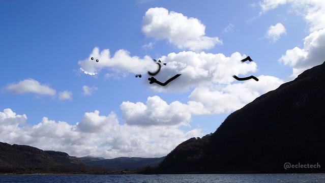 A photo of a blue sky with many fluffy white clouds taking up most of the frame, with a small strip of water at the bottom, and the silhouette of a mountain climbing up on the right hand side. There is a central cloud that has a bumpy plume of cloud sticking out from it, as if bursting forth from within. I have scribbled on it so the plume now has eyes and slightly goofy looking teeth, and the main cloud has a wide open mouth (from which the new cloud is emerging) and scrunched up eyes. It has legs stretched out behind, and arms bent up towards its mouth. 

Maybe this is how clouds are born. 

Maybe it's the result of an alien infestation (the alien looks very friendly if so).

Who knows?