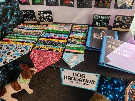 Rows of bandanas in all kinds of different printed fabric. Binders next to them. One is fun and family friendly and the other is adults only.