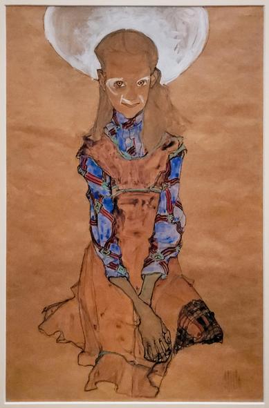 A portrait of a seated girl painted in Egon Schieles expressionist style, the figure is painted the same color as the background, with dark outlines and bright white highlights around the eyes and nose, wearing a blue shirt with red patterns, facing the viewer with eyes which appear as black dots surrounded by black circles with white highlights around them, a bright white light shines behind her head, she faces the viewer and gives an eerie glance.