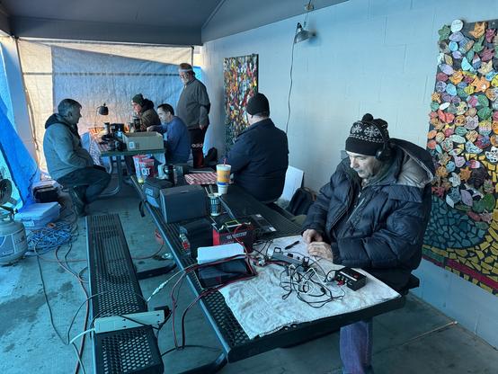 The view inside the shelter. Three stations on two picnic tables. (The fourth station was a few feet away at a completely open shelter).
