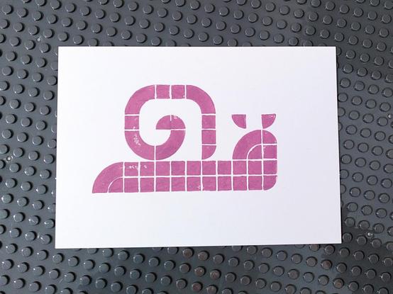 Lego print picturing a snail with a shell printed in a muted pink tone.