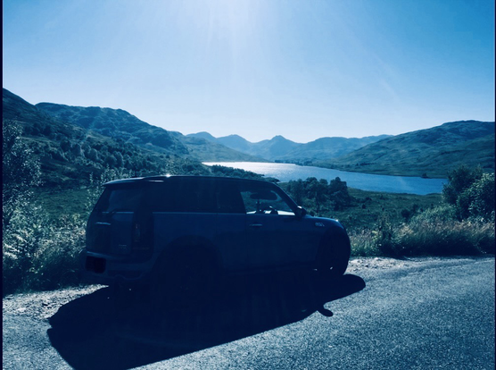 My mini campervan (!), ok, clubman roadside with a view of a loch and hills in the background.