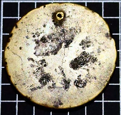 Hole in top, very little detail on coin.