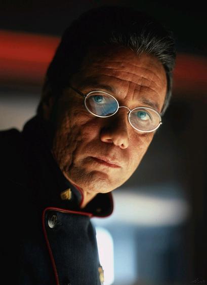 Image of a man wearing a futuristic uniform and oval glasses with metal frames.