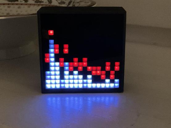 A divoom bluetooth speaker with a 16x16 matrix display connected wirelessly to a raspberry pi zero showing the spectrum of the music playing on the usb device connected to the raspi.