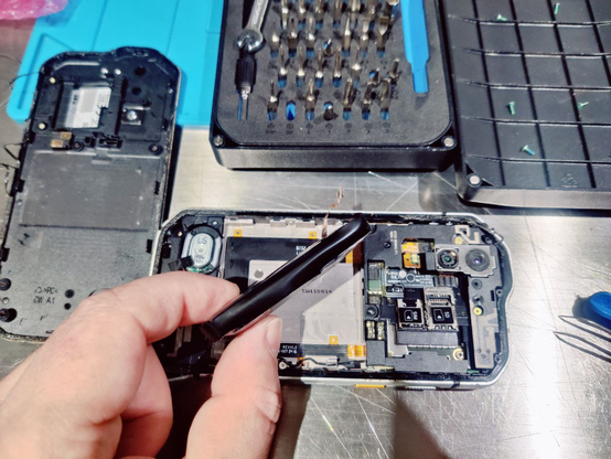 opened mobile phone with blown up pouch battery