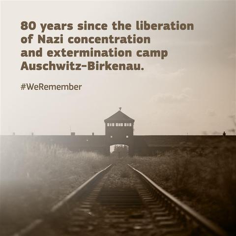 An image of the railway tracks leading to the main gate of Auschwitz-Birkenau, the Nazi concentration and extermination camp. The text reads, "80 years since the liberation of Nazi concentraition and extermination camp Auschwitz-Birkenau." Below is the hashtag #WeRemember.