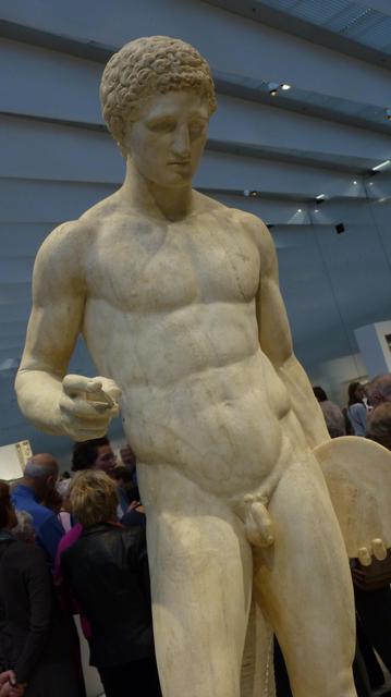 roman statue of a naked discus carrier, with finely sculpted musculature