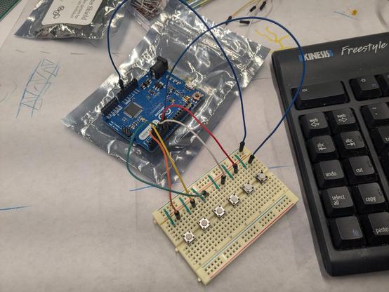 Arduino Leonardo microcontroller board wired to a bread board with 6 mini switches for testing our custom controller firmware.