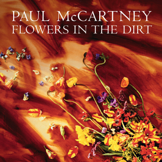 Album cover of Paul McCartney's Flowers in the Dirt (1989) showing dried flowers on shifting sand.