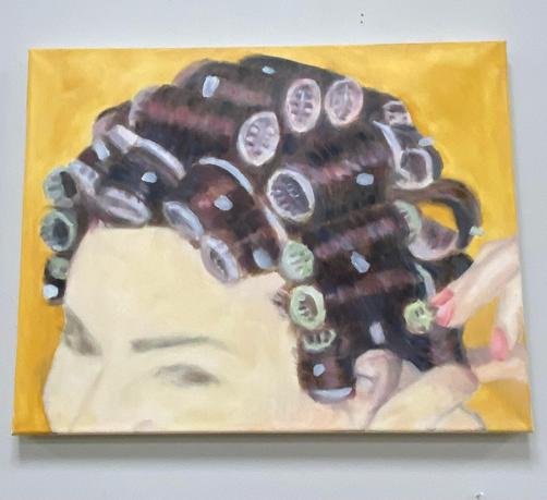 A hairdo is painted on a canvas. We see a lady with curls/rollers, her hair is reddish. The curlers are pink and light green. She is fixing them with her hands. We see her eyes, not her mouth. 
The background is warm yellow.