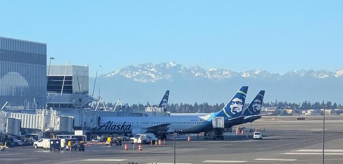 Alaskan Airlines jets in front of snow coveted mountains