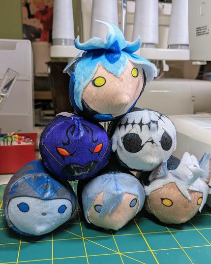 a stack of bean plush with Idia Shroud perched on the top