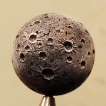pocked moon surface painted on a foam ball
