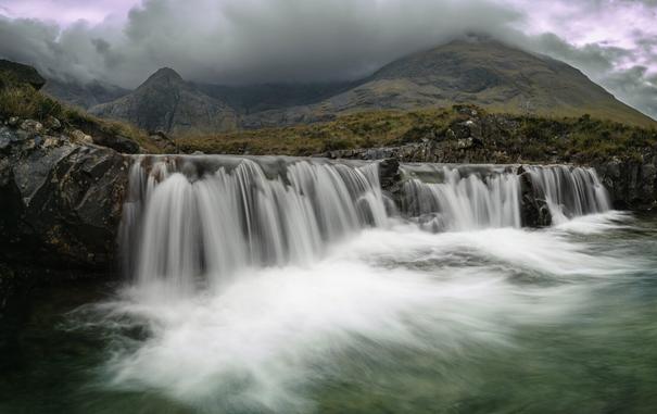 It's a picture of a waterfall surrounded by mountains. the place is called the fairy pools and it's true. It's magic.