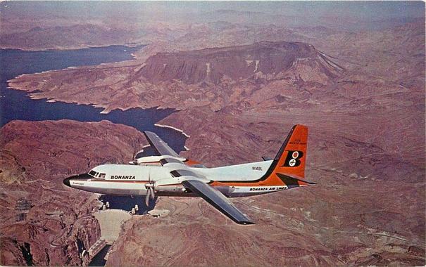 prop plane is over the hoover dam