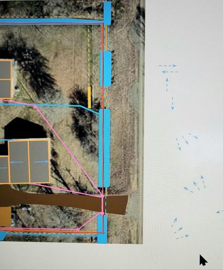 An aerial photograph of a property, with a border of white to the right and to the bottom. The aerial photo has on it rectangles for roofs, lines of blue for ditches, an irregular shape of brown for a driveway, fuchsia lines for power cables, dashed orange lines for fences, and solid red lines for property boundaries. In the white area to the right are many dashed blue lines with arrows pointing many different directions.