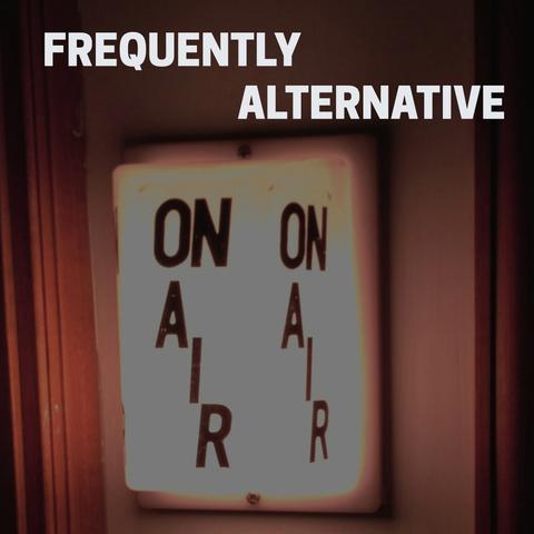 Plastic light fixture that says "ON AIR" mounted on a wood paneled wall. The light is turned on, indicating a dj is currently broadcasting.