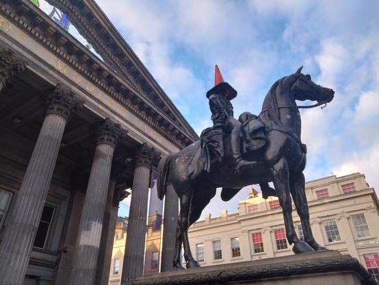 Statue of Duke of Wellington outside the Glasgow museum of modern art. With a traffic cone on his head
