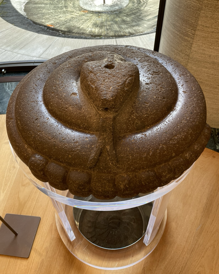 photo of sculpture on a pedestal display at museum - large coiled rattlesnake