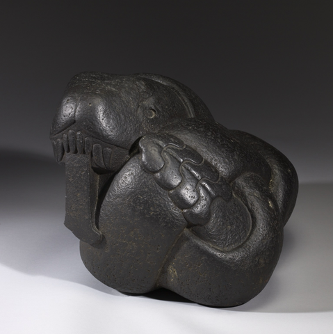 official museum photo of the object on gradient grey background, back profile view showing tail