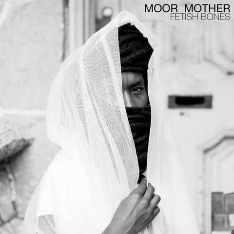The album cover is a black and white photo of the artist looking at the camera, wearing dark cloth wrapped around their head and face, with a veil of white net material draped over that and covering the right eye, and held closed with their right hand. The background is blurry but looks like they're standing in front of a door. The artist name is in black font in the top right corner, with the album name in smaller font directly below.