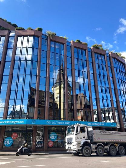 Reflection of an old Geneva building in a new one