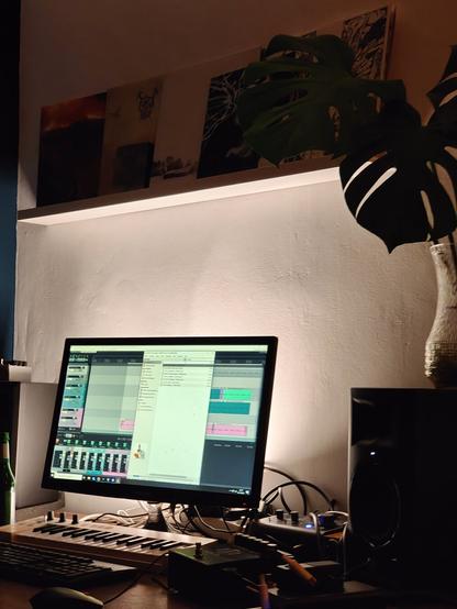photo of a desk with a computer and audio equipment spread around.
